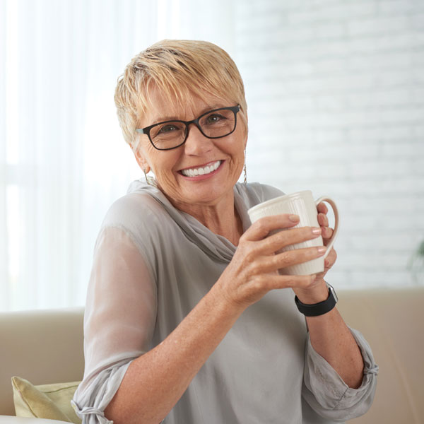 smiling middle aged woman with coffee cup